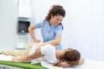 young-woman-doctor-chiropractor-osteopath-fixing-lying-womans-back-with-hands-movements-visit-manual-therapy-clinic-professional-chiropractor-work (1).jpg